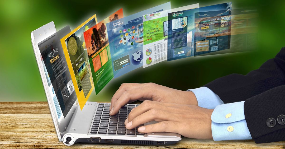 A man sits at a laptop computer, with several business web pages floating out from the screen beside him.